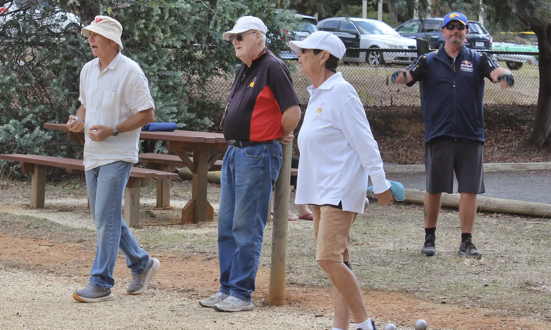 Bruce, Geoff and Sandy focus on the game while Mick focuses on his warm-up routine.
